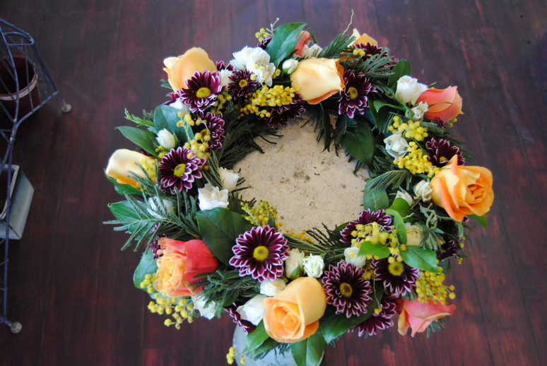 A sympathy wreath of mixed seasonal flowers
