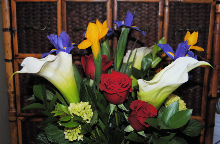 A modern arrangement of calla lilies and red roses
